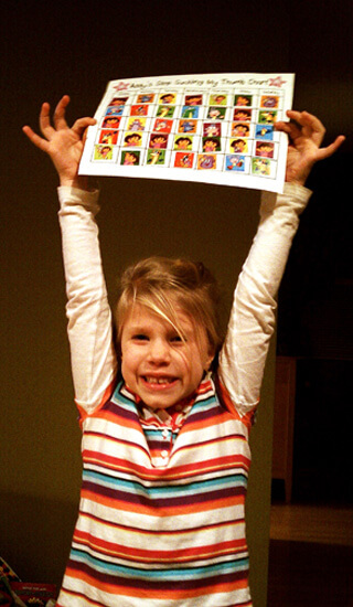 Grinning girl holding up a paper over her head