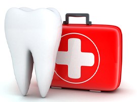 Model of a tooth next to a first-aid kit