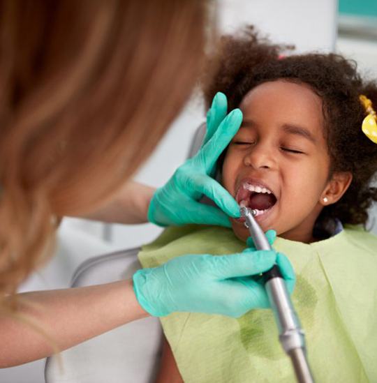 Little girl receiving a dental checkup and cleaning in Downers Grove