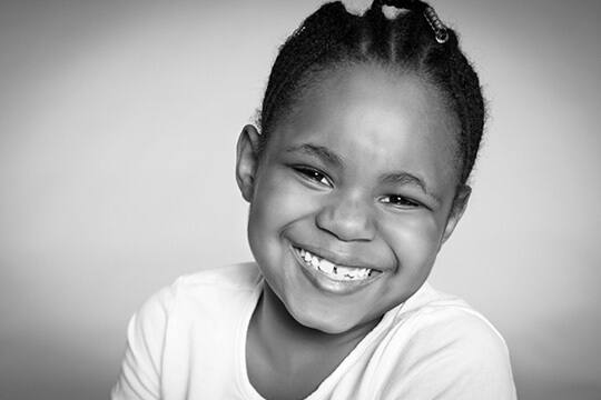 Young child grinning at camera