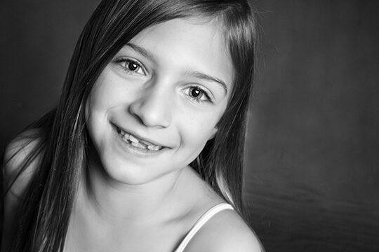 Smiling girl with a few missing teeth