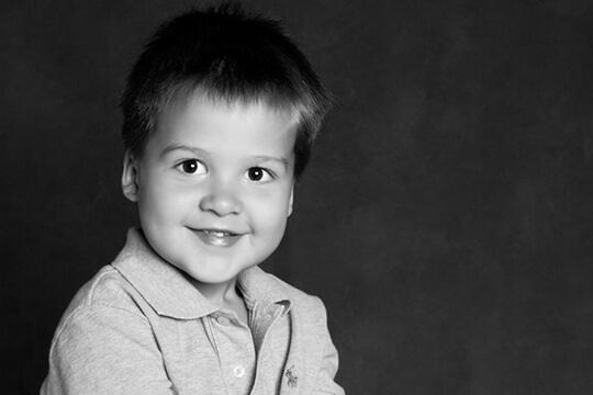 Grinning boy with fuzzy spiky hair