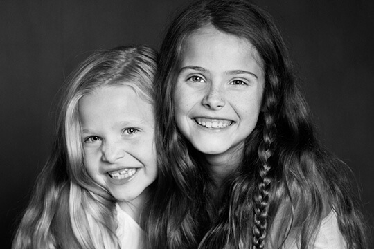 Two young girls smiling together