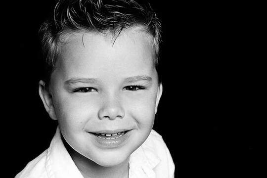Smiling young boy with spiky hair