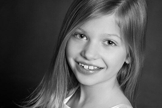 Smiling young girl with long straight hair