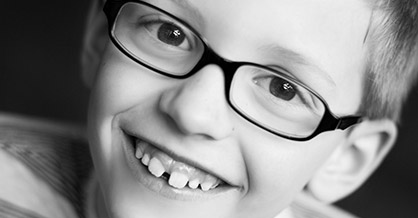 Smiling young boy with glasses