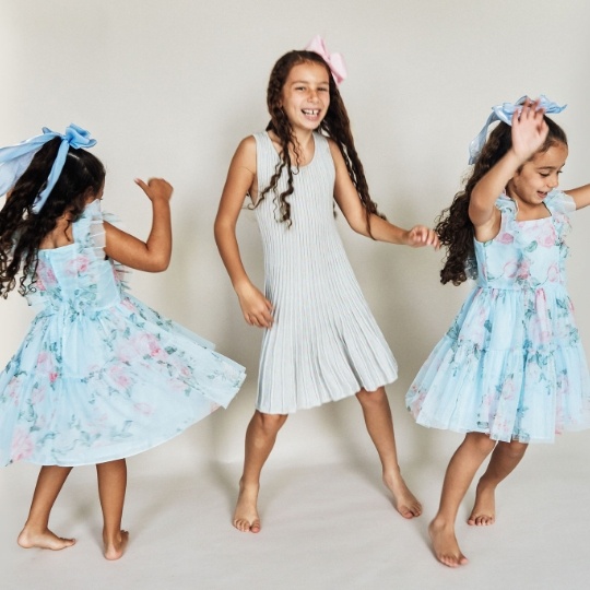 Pediatric dentist showing a model of the teeth to a young patient