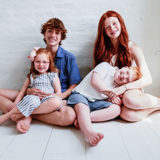 Smiling group of kids with backpacks