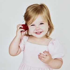 Smiling toddler boy with only two lower teeth