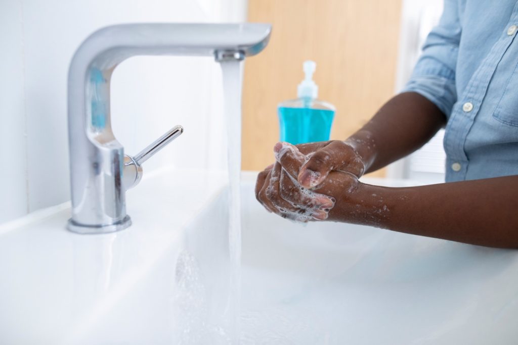 Someone washing their hands before seeing a pediatric dentist in Hinsdale 