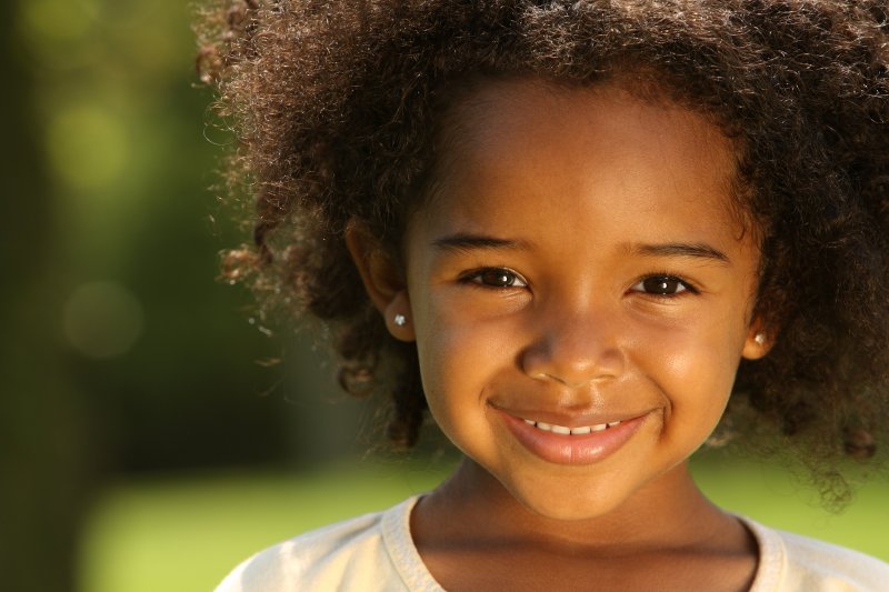 little girl smiling after seeing children’s dentist