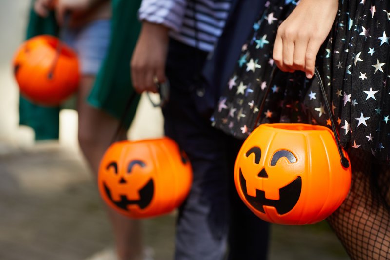 kids with pumpkin buckets for trick-or-treating
