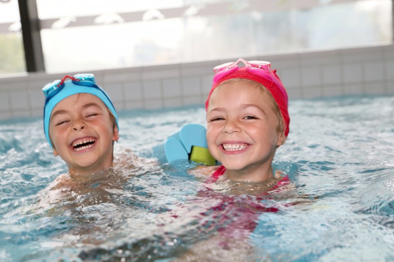 two kids swimming in a pool