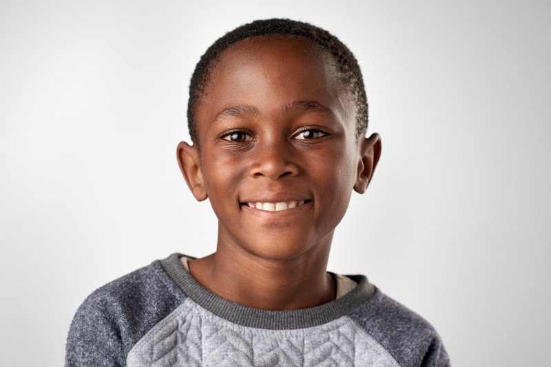 a young boy with a healthy smile