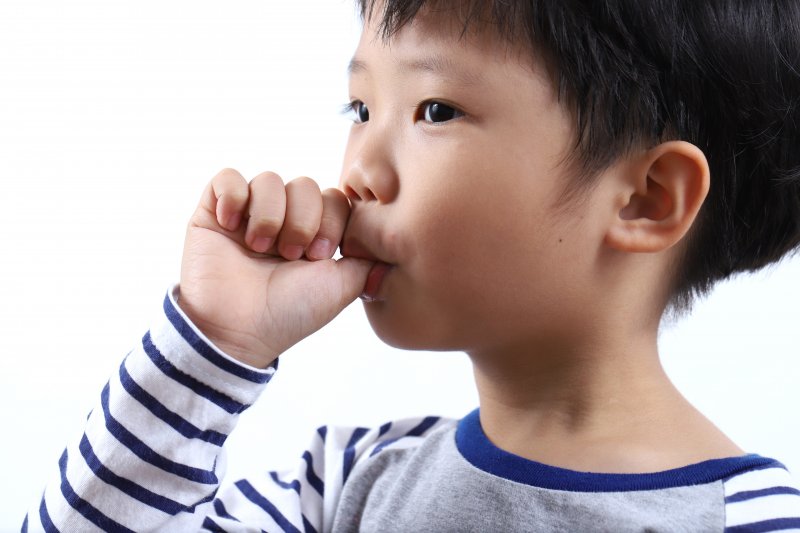 child sucking his thumb