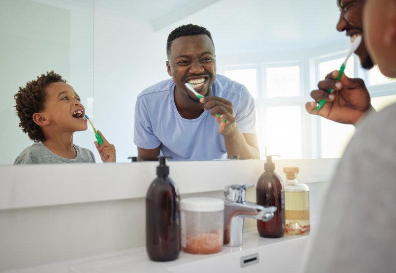 dad and child brushing their teeth