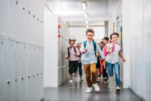 children running through a school hallway