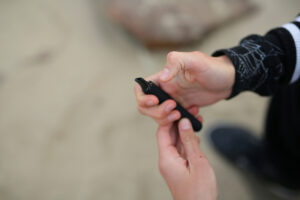 a teen holding a vape in their hand