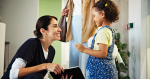 a pediatric dentist smiling and speaking with a child